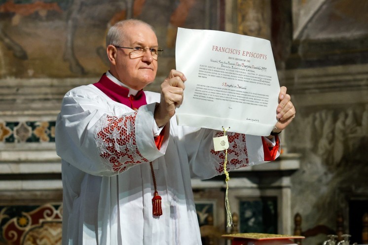 A person holds a declaration from Pope Francis.
