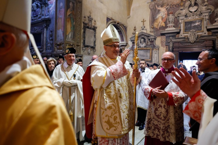 Cardinal Pierbattista Pizzaballa, patriarch of Jerusalem, greets the faithful before celebrating Mass.