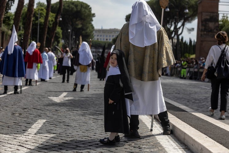 A little girl in a procession through Rome