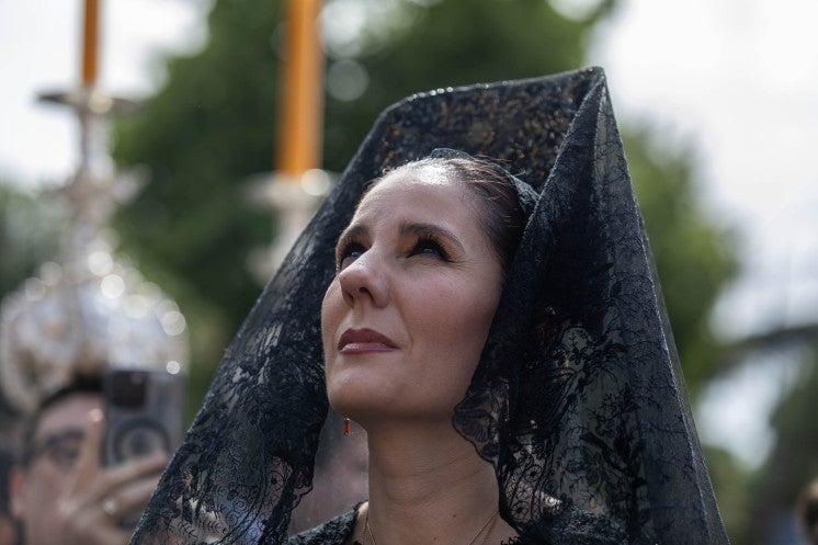 A woman walks in procession in Rome