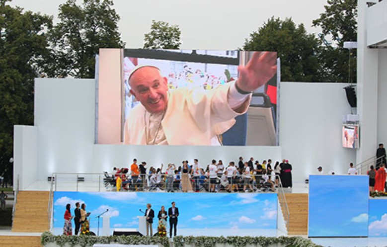 WYD 2016 - Pope Francis is pictured on a screen en route to a welcoming ceremony