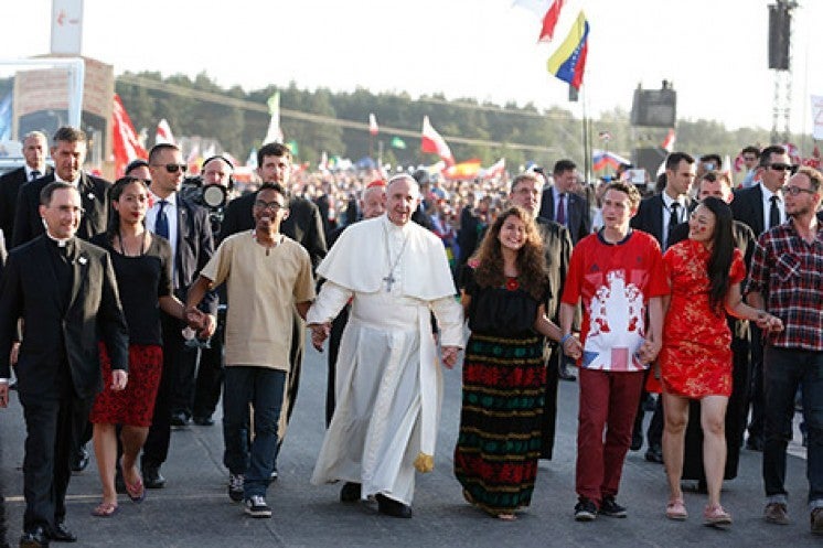 Pope Francis walks with World Youth Day pilgrims as he arrives for a July 30 prayer vigil at the Field of Mercy in Krakow, Poland. (CNS photo/Paul Haring)