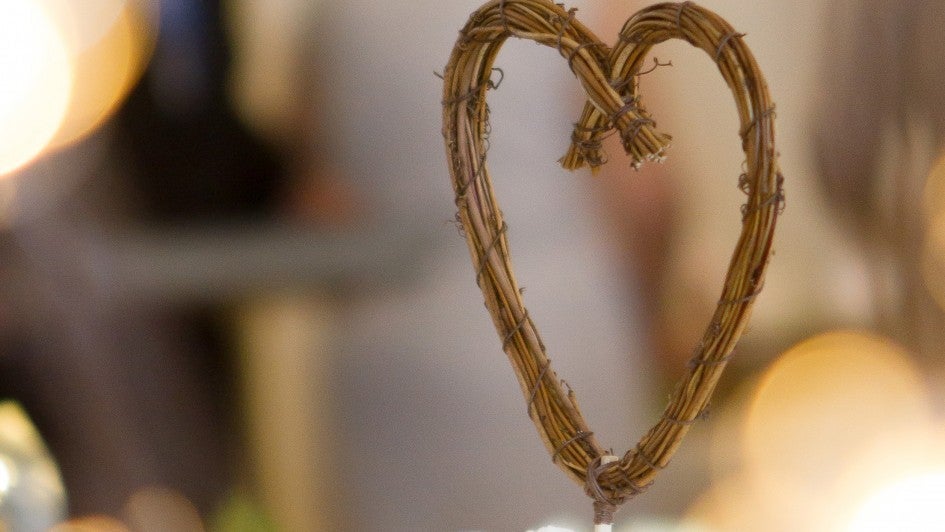 Close-up of Wedding Cake with wood heart and large lights behind it