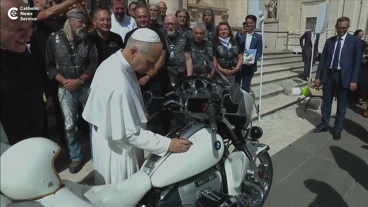 Pope Leo signs a BMW motorcycle